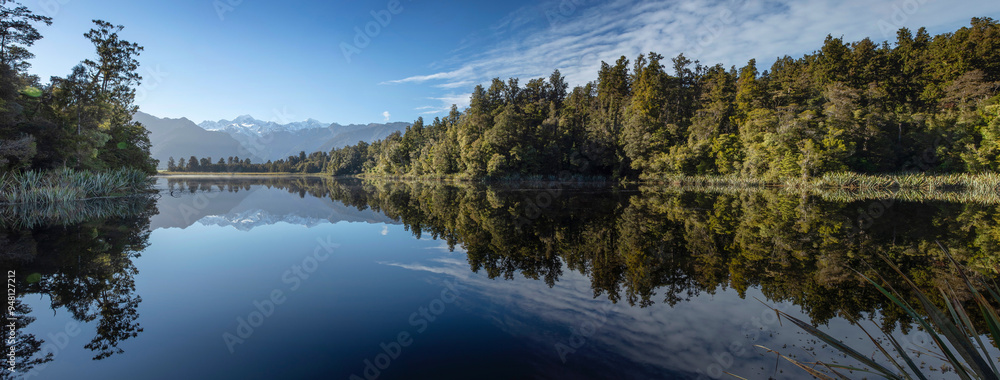 Reflections of the Fox Glacier in mirror lake Matheson. South Island New Zealand. Lake surrounded by forest. Panorama. Reflections of the Fox Glacier in mirror lake Matheson. South Island New Zealand. Lake surrounded by forest. Panorama.