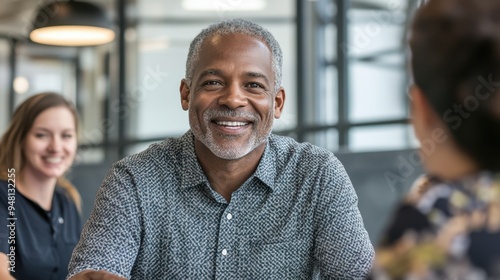 Smiling Senior African American Man in Business Meeting with Colleagues