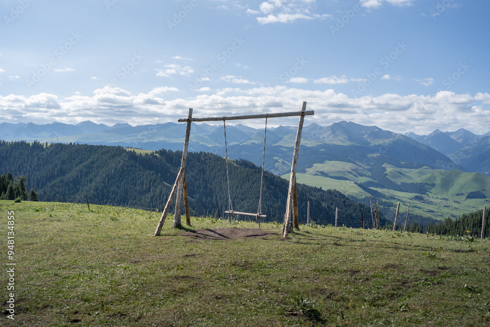 Swing on Karajun Grassland in Xinjiang during Summer Swing on Karajun Grassland in Xinjiang during Summer