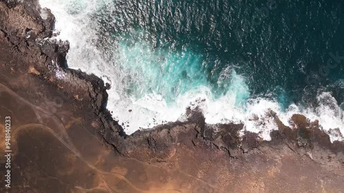 Aerial view of the rocky shore and dramatic coastline with waves crashing against the blue ocean, Los Charcones, Playa Blanca, Lanzarote, Canary Islands, Spain. photo