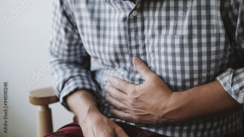 Stressed individual clutching their stomach to signify pain