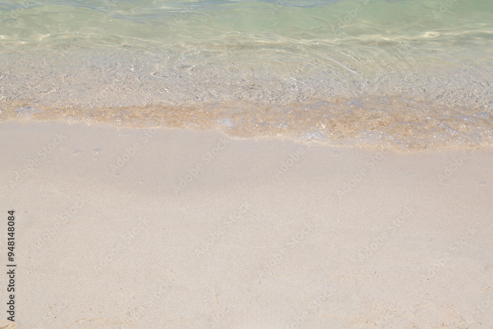 gentle waves lapping the sandy shore of a beach with clear sea water gentle waves lapping the sandy shore of a beach with clear sea water
