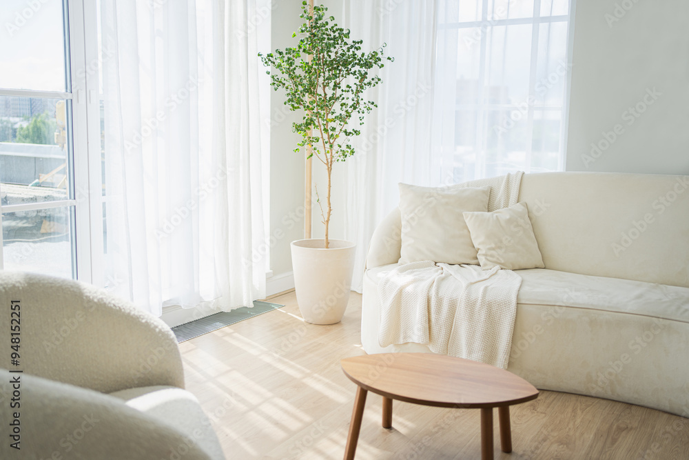 Fototapeta premium Stylish loft bedroom interior. Spacious design apartment with light walls large windows white couch sofa and armchair. Clean modern decoration with elegant furniture in minimalist Scandinavian style