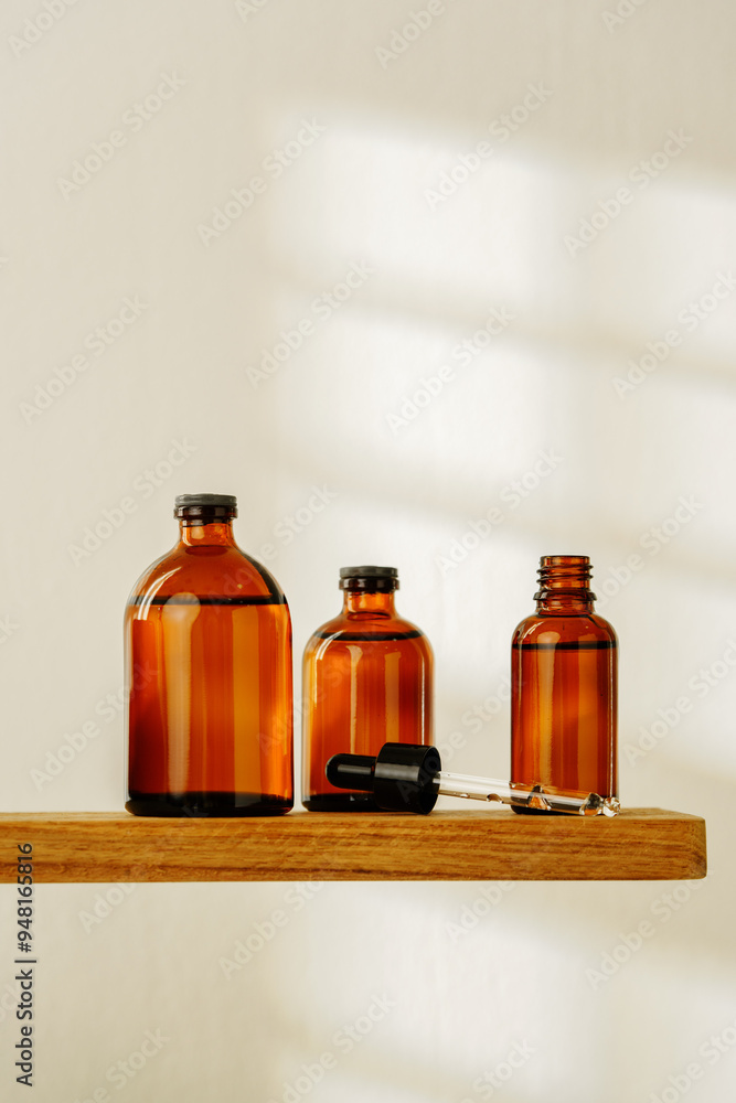 Collection of Amber Glass Dropper Bottles Displayed on a Minimalist White Surface in Natural Light Collection of Amber Glass Dropper Bottles Displayed on a Minimalist White Surface in Natural Light