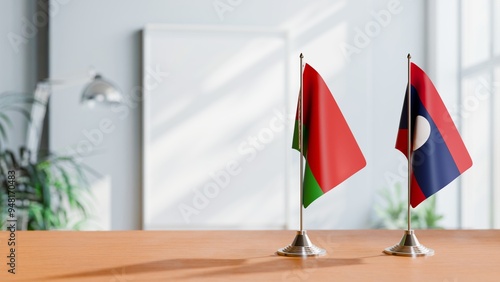 FLAGS OF BELARUS AND LAOS ON TABLE photo