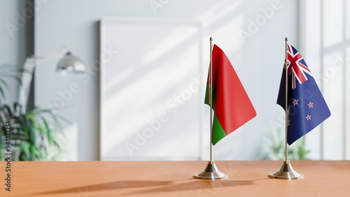 FLAGS OF BELARUS AND NEW ZEALAND ON TABLE photo