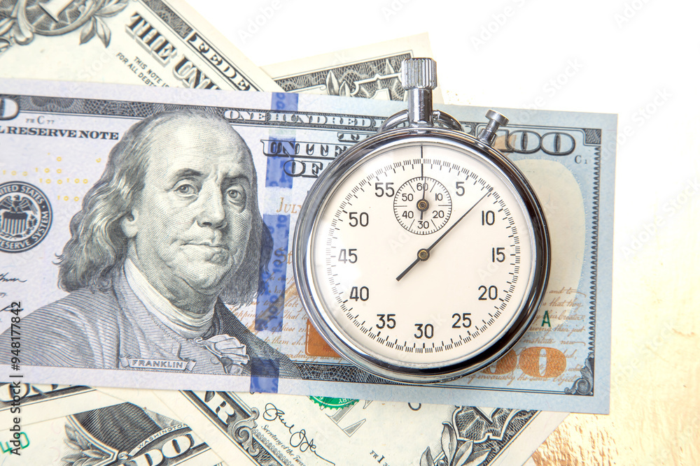 mechanical stopwatch on the background of dollars. Part time accuracy for business. business and finance time. mechanical stopwatch on the background of dollars. Part time accuracy for business. business and finance time.
