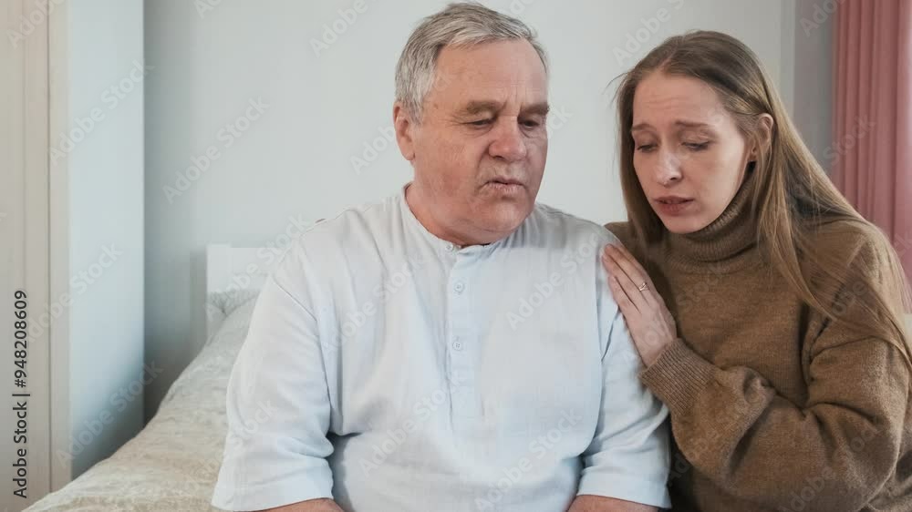 Loving adult daughter comforting sad senior father, hugs him while sitting on the bed. Woman caring older man at home. Family support and relationship, caring and children love concept Loving adult daughter comforting sad senior father, hugs him while sitting on the bed. Woman caring older man at home. Family support and relationship, caring and children love concept