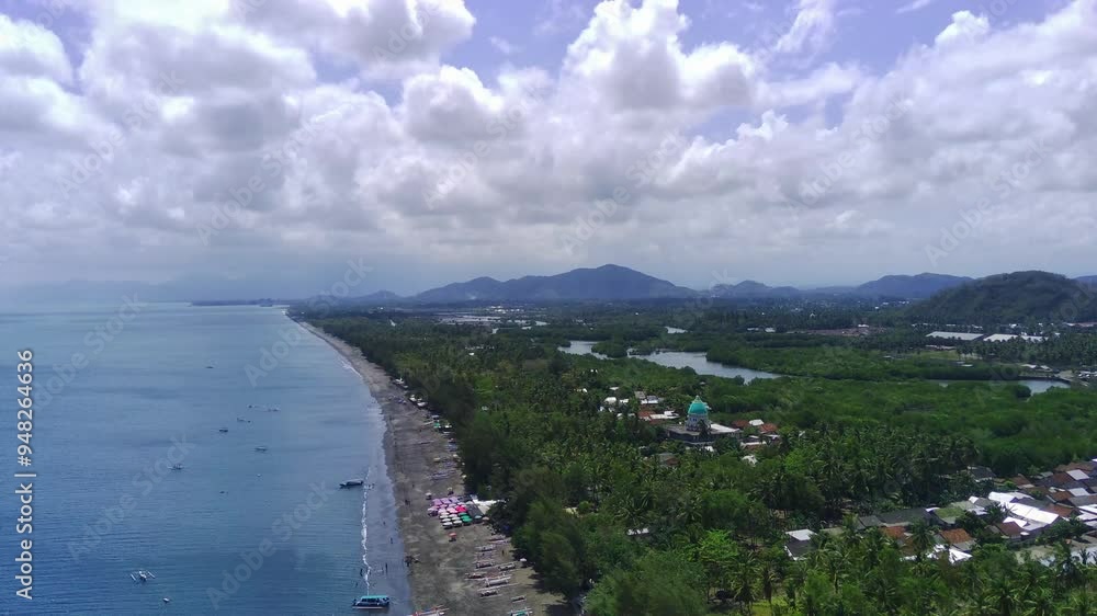 A breathtaking aerial view of Cemare Beach in Lombok, Indonesia, showcasing a lush coconut plantation, a tranquil bay, and majestic mountains under a dramatic sky. A breathtaking aerial view of Cemare Beach in Lombok, Indonesia, showcasing a lush coconut plantation, a tranquil bay, and majestic mountains under a dramatic sky.