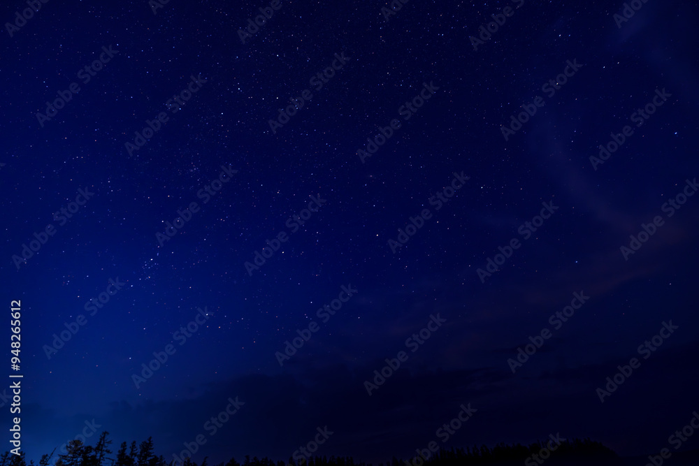 Star-filled night sky with a meteor streak and clouds Star-filled night sky with a meteor streak and clouds