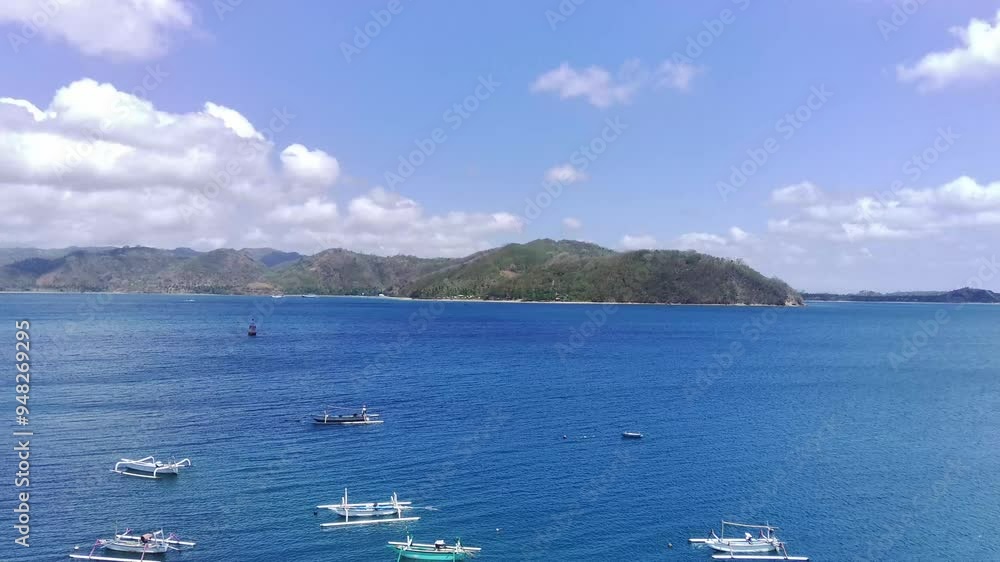A breathtaking aerial view of Cemare Beach in Lombok, Indonesia, showcasing a lush coconut plantation, a tranquil bay, and majestic mountains under a dramatic sky. A breathtaking aerial view of Cemare Beach in Lombok, Indonesia, showcasing a lush coconut plantation, a tranquil bay, and majestic mountains under a dramatic sky.
