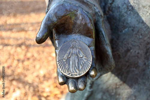 Shrine of Our Lady of the Rosary of Namyang, Hwaseong-si, Gyeonggi-do, South Korea - November 14, 2021: Close-up of a right hand statue holding round plate with Jesus carving photo