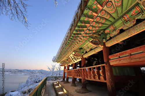 Gangneung-si, Gangwon-do, South Korea - December 25, 2021: Winter view of Gyeongpodae Pavilion(Treasure No 2046) against snow covered Gyeongpo Lake photo