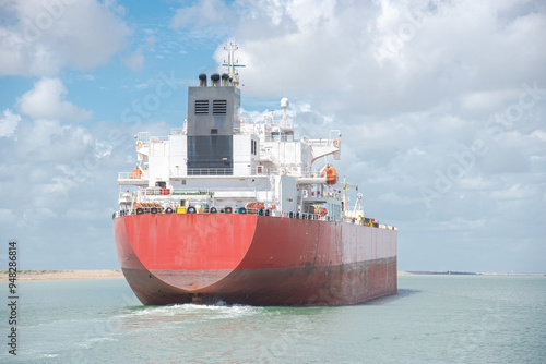 Splash water stern of crude oil tanker ship, bridge deck, crane, VHF radio frequencies antennas satellite signals navigation radar, bulk transport sail thru South Padre Island, Brownsville port photo