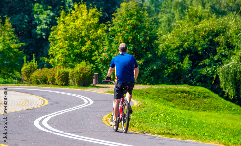Fototapeta premium Cyclist ride on the bike path in the city Park 