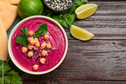 Tasty beetroot hummus in bowl and products on wooden table, flat lay. Space for text