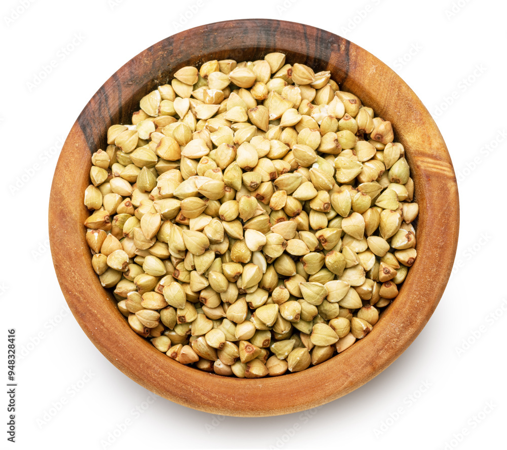 Wooden bowl of raw buckwheat on white background. File contains clipping path. Top view. Wooden bowl of raw buckwheat on white background. File contains clipping path. Top view.