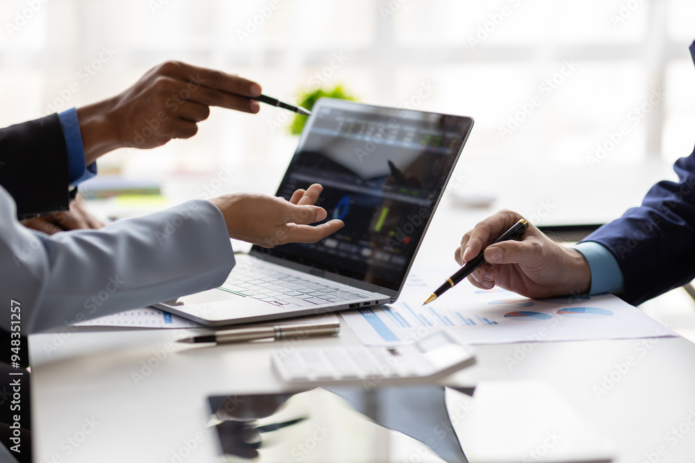 Businessman meeting with consultants discussing data analysis, charts and graphs in financial reports to plan investments and increase company profits. Strategy analysis and business planning meeting. Businessman meeting with consultants discussing data analysis, charts and graphs in financial reports to plan investments and increase company profits. Strategy analysis and business planning meeting.