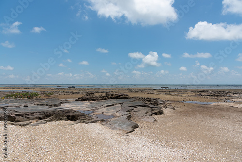 The landscape of coastal reefs after low tide and the fishing grounds in the distance