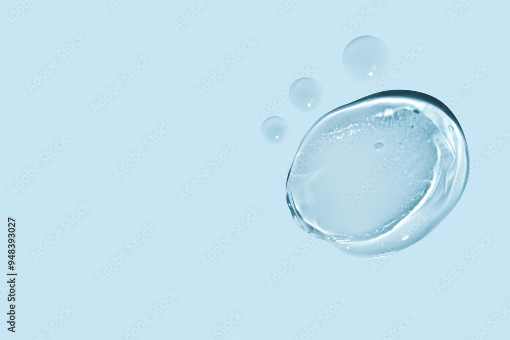 composition of smears of transparent gel and drops of liquid on a blue background. composition of smears of transparent gel and drops of liquid on a blue background.