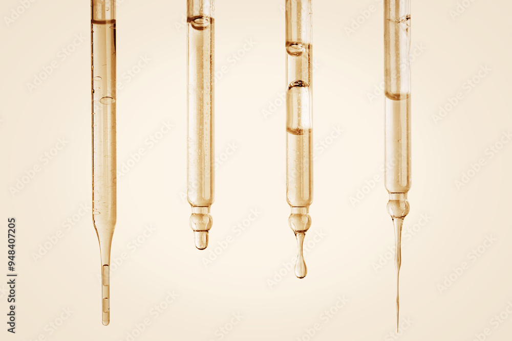 Set of Cosmetic pipettes with yellow liquid dripping. On a yellow background. Natural cosmetics, gold, acids, extract, serum, serum. Set of Cosmetic pipettes with yellow liquid dripping. On a yellow background. Natural cosmetics, gold, acids, extract, serum, serum.