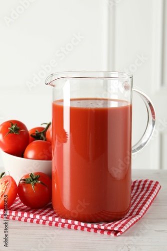 Wallpaper Mural Tasty tomato juice in jug and vegetables on light wooden table indoors Torontodigital.ca