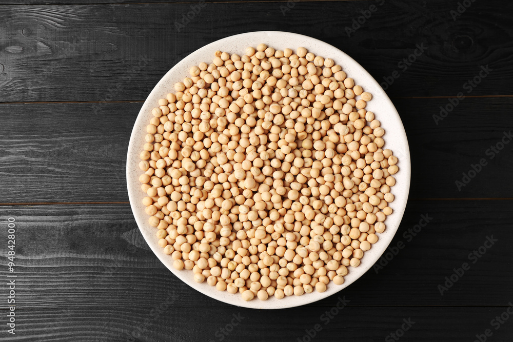 Dried peas in bowl on black wooden table, top view Dried peas in bowl on black wooden table, top view