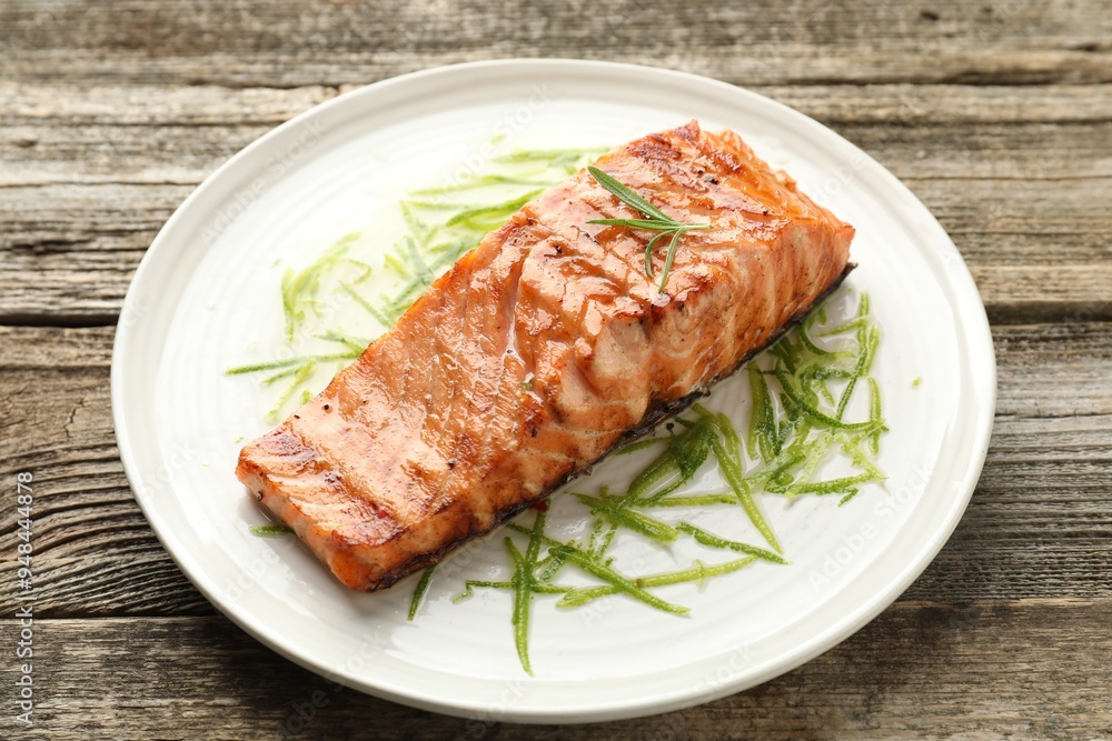 Delicious grilled salmon fillet served on wooden table, closeup Delicious grilled salmon fillet served on wooden table, closeup
