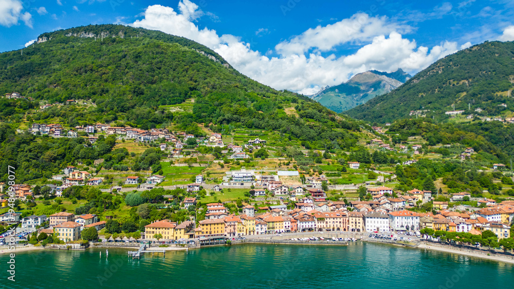 An aerial view of Domaso, a beautiful village nestled on the shores of Lake Como, Italy, captured by a drone. This charming destination is known for its picturesque lakeside scenery, quaint streets An aerial view of Domaso, a beautiful village nestled on the shores of Lake Como, Italy, captured by a drone. This charming destination is known for its picturesque lakeside scenery, quaint streets