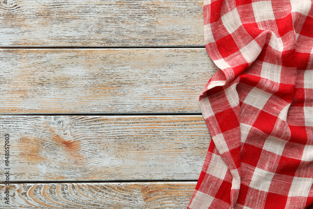 Red checkered picnic tablecloth on old wooden table, top view. Space for text Red checkered picnic tablecloth on old wooden table, top view. Space for text