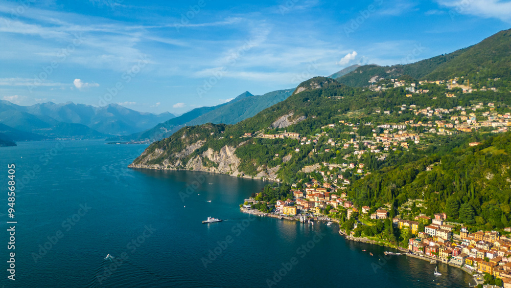 An aerial view of Varenna, a renowned tourist destination on the shores of Lake Como, Italy, captured by a drone. This famous village is celebrated for its colorful buildings, historic sites An aerial view of Varenna, a renowned tourist destination on the shores of Lake Como, Italy, captured by a drone. This famous village is celebrated for its colorful buildings, historic sites