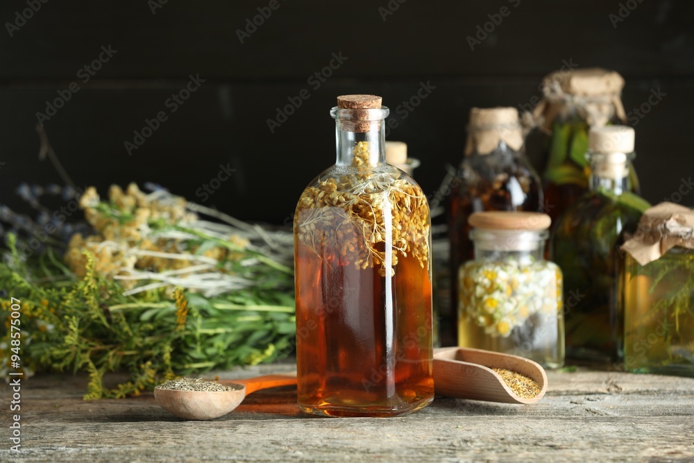 Different tinctures and herbs on wooden table Different tinctures and herbs on wooden table