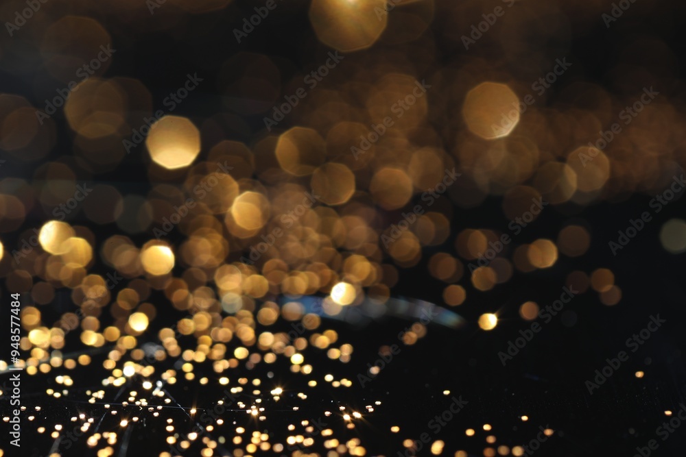 Beautiful shiny golden glitter on black background, closeup Beautiful shiny golden glitter on black background, closeup