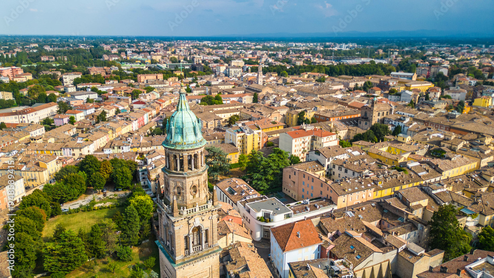 Fototapeta premium An aerial view of Parma, Italy, showcasing the iconic Cattedrale di Parma and the Battistero di Parma, captured by a drone. This historic city is known for its rich cultural heritage