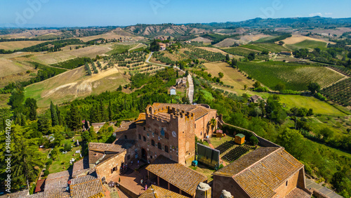 An aerial view of Certaldo, a charming medieval town in Tuscany, Italy, captured by a drone. Certaldo is known for its well-preserved historic center, characterized by ancient brick buildings