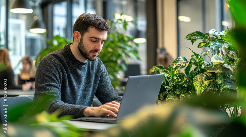 Businessman working on a laptop in a coworking space Businessman working on a laptop in a coworking space
