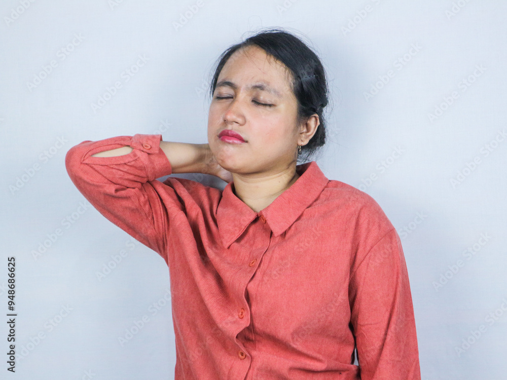 Beautiful young Asian businesswoman suffering shoulders and back pain, isolated on white background Beautiful young Asian businesswoman suffering shoulders and back pain, isolated on white background