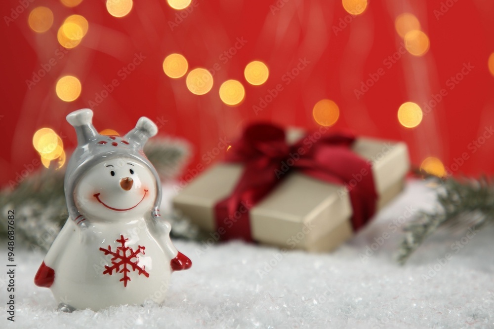 Cute decorative snowman on artificial snow, closeup. Space for text Cute decorative snowman on artificial snow, closeup. Space for text