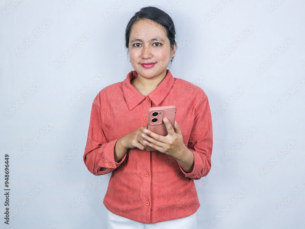 Beautiful asian business Woman wearing formal pink shirt, hold smartphone looking at camera Beautiful asian business Woman wearing formal pink shirt, hold smartphone looking at camera