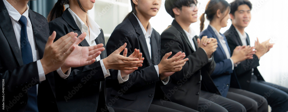 Business people gather in line at corporate event to applaud achievement and celebrate company's success on motivation speech or business presentation meeting with audience in panorama banner. Shrewd