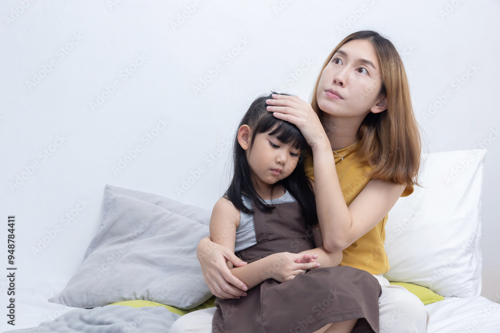 Mother hug her sick little girl on her bed Mother hug her sick little girl on her bed