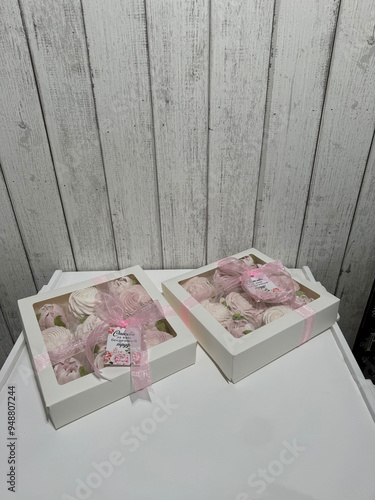 A box of homemade marshmallows. Tied with a ribbon. The tags have the inscription in Russian Thank you for your invaluable work. Flowers made of marshmallow.