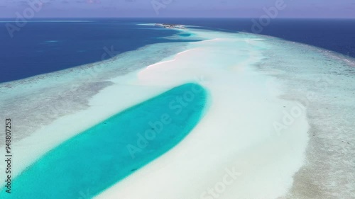 Aerial view of a beautiful sandbank and lagoon with boats and a reef in the turquoise Indian Ocean, Rashdoo, Maldives. photo