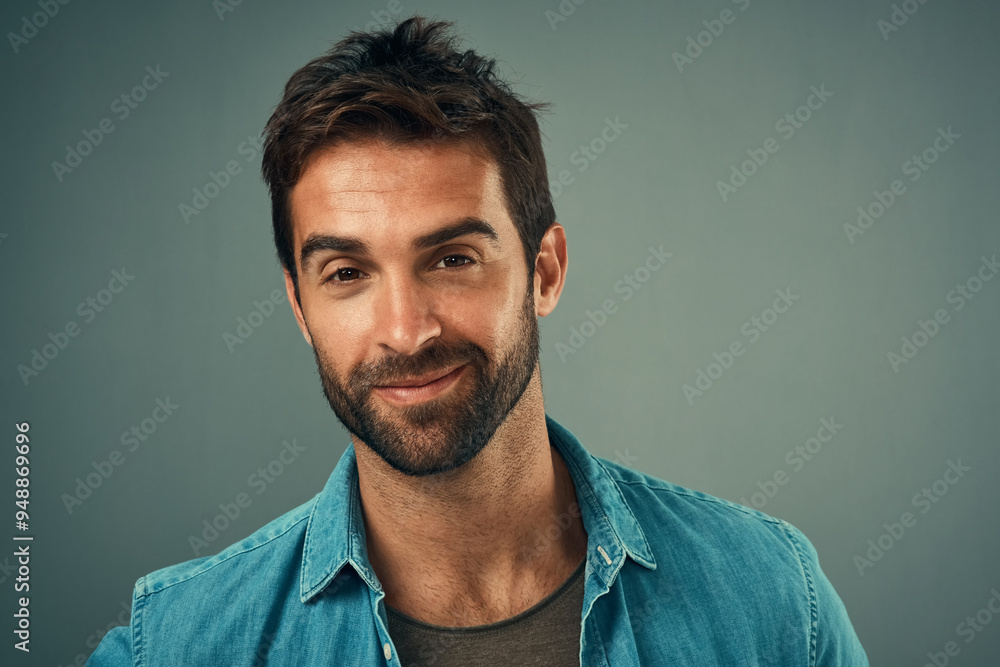 Fototapeta premium Happy man, portrait and fashion with young face in confidence for style on a studio background. Attractive or handsome male person or model with smile in denim or casual clothing on mockup space