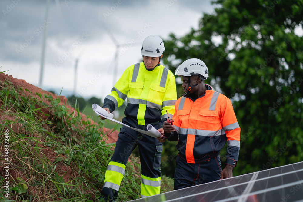 Fototapeta premium Service engineer inspects and maintains solar panels in a cultivation area, promoting clean energy.
