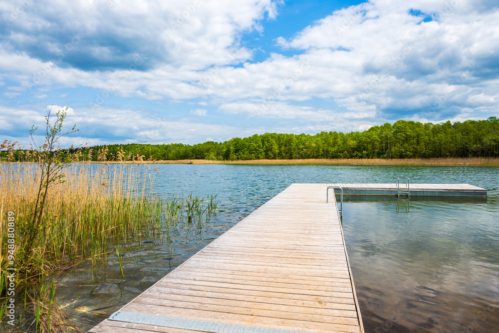 Naklejka premium Wooden pier on shore of Kamedul lake, Suwalski Landscape Park, Podlasie, Poland