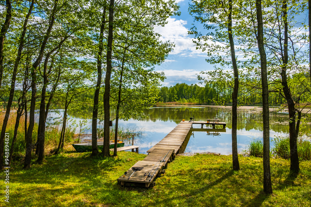 Wooden pier at beautiful lake during sunny summer day, Suwalski Landscape Park, Podlasie, Poland