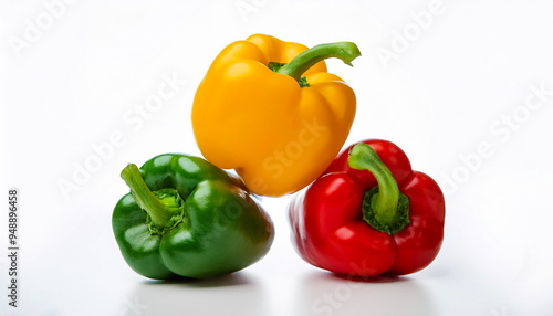 three capsicum green yellow and red lying on each other isolated on white background.