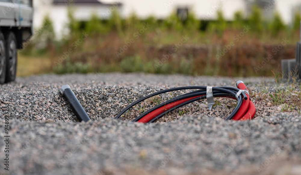 Naklejka premium Hoses and pipes sticking up from the ground at a building site.