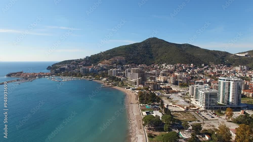 A stunning aerial view of a city by the water, with mountains in the background. The natural landscape, lake, and beach create a picturesque scene for travel enthusiasts A stunning aerial view of a city by the water, with mountains in the background. The natural landscape, lake, and beach create a picturesque scene for travel enthusiasts